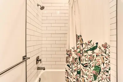 a shower curtain with a bird pattern on it in a bathroom at Central Pet-Friendly Apt - Minutes to Dtwn! in Philadelphia