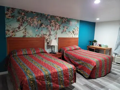a hotel room with two beds and blue walls at Stardust Motel in Duncannon