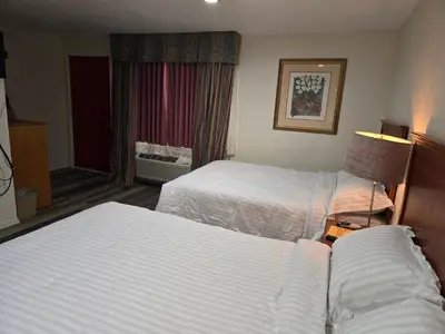 a hotel room with two beds and a window at Stardust Motel in Duncannon