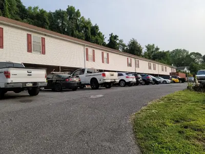 a row of cars parked in front of a building at Stardust Motel in Duncannon