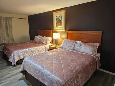 a hotel room with two beds and a window at Stardust Motel in Duncannon