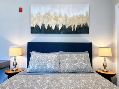 a bedroom with a blue bed with two lamps at Stay at Luna on Ridge Ave in Philadelphia