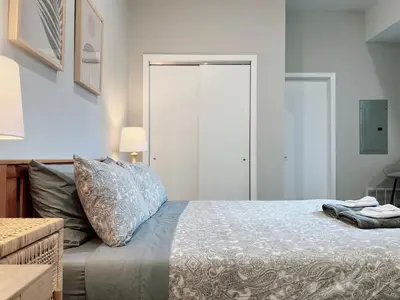 a bedroom with a bed with a blue comforter at Stay at Luna on Ridge Ave in Philadelphia