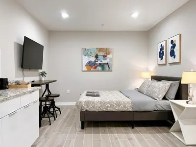 a bedroom with a bed and a kitchen with a table at Stay at Luna on Ridge Ave in Philadelphia