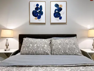 a bedroom with a bed with two pictures on the wall at Stay at Luna on Ridge Ave in Philadelphia