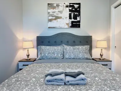 a bedroom with a bed with blue pillows and two lamps at Stay at Luna on Ridge Ave in Philadelphia