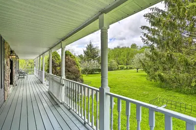 a porch of a house with a green yard at Pet-Friendly Pond View Loft with Private Pool! in Walden