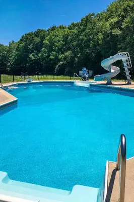 a large swimming pool with a water slide at Pet-Friendly Pond View Loft with Private Pool! in Walden
