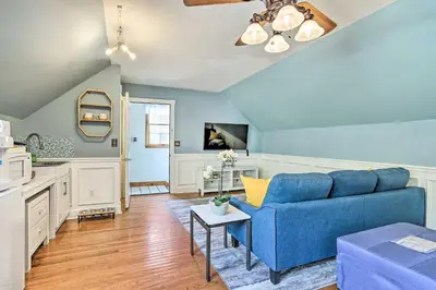 a living room with a blue couch and a table at Pet-Friendly Pond View Loft with Private Pool! in Walden
