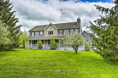 a large house with a large yard with green grass at Pet-Friendly Pond View Loft with Private Pool! in Walden