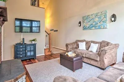 a living room with a couch and a tv at Community Perks and Deck Lake Harmony Townhome! in Lake Harmony