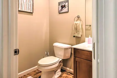 a bathroom with a toilet and a sink at Community Perks and Deck Lake Harmony Townhome! in Lake Harmony