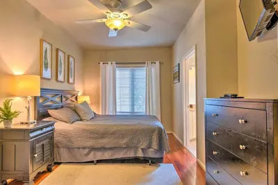 a bedroom with a bed with a ceiling fan and a dresser at Community Perks and Deck Lake Harmony Townhome! in Lake Harmony