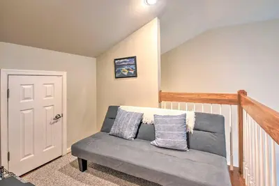 a living room with a couch with pillows on it at Community Perks and Deck Lake Harmony Townhome! in Lake Harmony