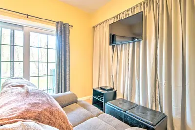 a living room with a couch and a large window at Community Perks and Deck Lake Harmony Townhome! in Lake Harmony