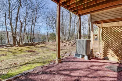 a screened in porch of a house with a heater at Community Perks and Deck Lake Harmony Townhome! in Lake Harmony