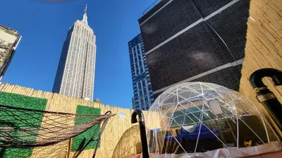 two glass domes in front of a tall building at Hotel and the City, Rooftop City View in New York