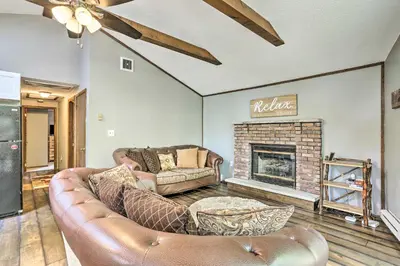 a living room with a couch and a fireplace at Walk to Lake and Beach Pocono Cabin with Fire Pit in Pocono Lake