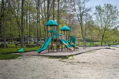 a playground in a park with a slide at Walk to Lake and Beach Pocono Cabin with Fire Pit in Pocono Lake