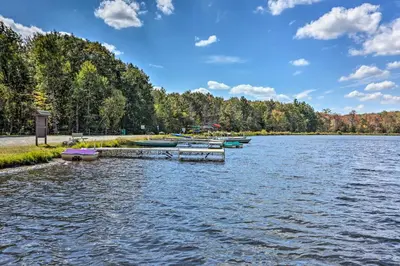 a group of boats docked on a lake at Walk to Lake and Beach Pocono Cabin with Fire Pit in Pocono Lake