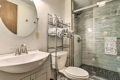 a bathroom with a sink and a toilet and a shower at Walk to Lake and Beach Pocono Cabin with Fire Pit in Pocono Lake