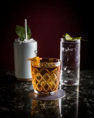 two cocktails sitting on a table with a drink at Hotel 32 32 in New York