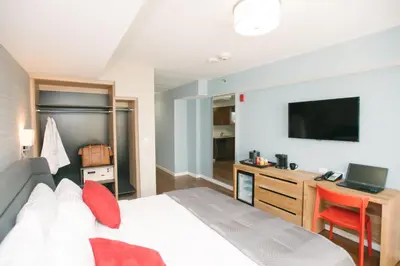a bedroom with a bed and a desk with a television at Hotel 32 32 in New York