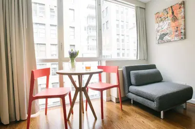 a dining room with a table and chairs and a window at Hotel 32 32 in New York
