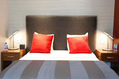 a bedroom with a large bed with red pillows at Hotel 32 32 in New York