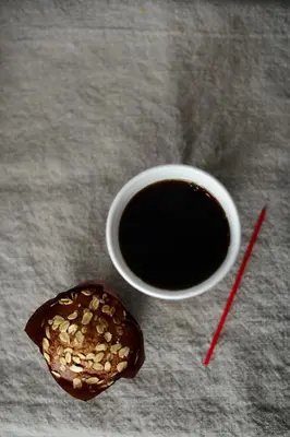 a cup of coffee next to a donut and a drink at Lex Hotel NYC in New York