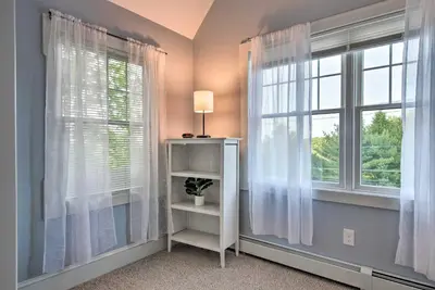 a room with two windows and a table with a lamp at Large Yard and Games Edgewater Escape in Paupack! in Paupack