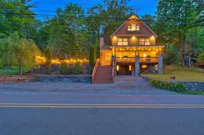 a house with lights on the front of it at Large Yard and Games Edgewater Escape in Paupack! in Paupack