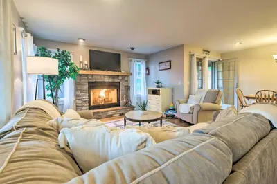 a living room with a couch and a fireplace at Large Yard and Games Edgewater Escape in Paupack! in Paupack