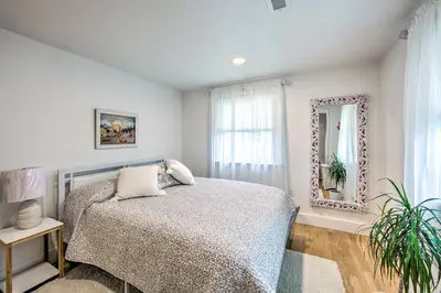 a bedroom with a bed and a mirror at 3 Mi to Dutch Wonderland Serene Home with Deck in Lancaster