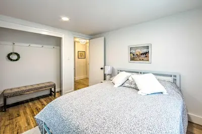 a bedroom with a bed with a blue and white comforter at 3 Mi to Dutch Wonderland Serene Home with Deck in Lancaster