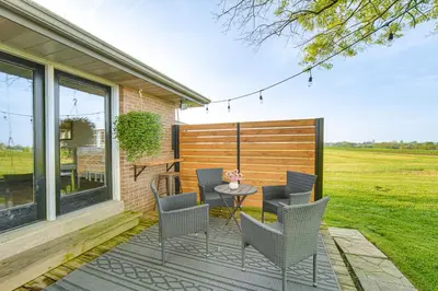 a patio with chairs and a table on a house at 3 Mi to Dutch Wonderland Serene Home with Deck in Lancaster