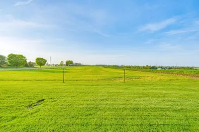 a field of green grass with two poles in it at 3 Mi to Dutch Wonderland Serene Home with Deck in Lancaster