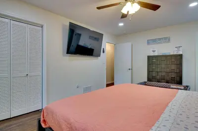a bedroom with a bed and a flat screen tv at 2 Game Rooms! Family Poconos Home 9 Mi to Slopes in Pocono Summit