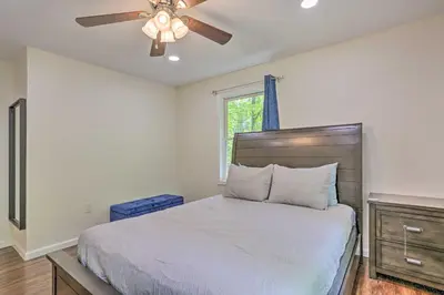 a bedroom with a bed and a ceiling fan at 2 Game Rooms! Family Poconos Home 9 Mi to Slopes in Pocono Summit