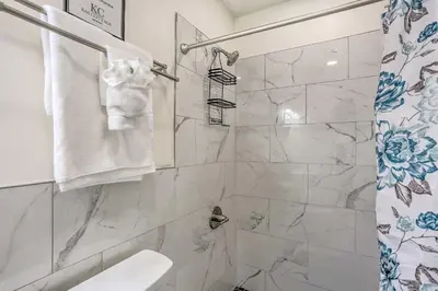 a bathroom with a shower with a toilet and a sink at 2 Game Rooms! Family Poconos Home 9 Mi to Slopes in Pocono Summit