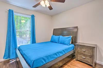 a bedroom with a bed with blue sheets and a window at 2 Game Rooms! Family Poconos Home 9 Mi to Slopes in Pocono Summit