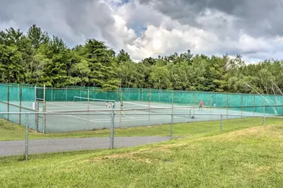 two tennis courts with two dogs on them at Near Lakes and Resorts Pet-Friendly Long Pond Abode in Long Pond