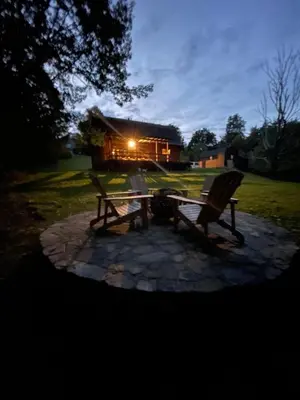 a couple of benches sitting on a stone patio at Afton Cabin in Afton