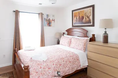 a bedroom with a bed and a window at Beautifully Designed & Spacious Apartment in Newark 10mins from EWR Airport, Close to NYC and Beth Israel Hospital in Newark