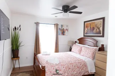 a bedroom with a bed and a ceiling fan at Beautifully Designed & Spacious Apartment in Newark 10mins from EWR Airport, Close to NYC and Beth Israel Hospital in Newark