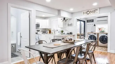 a kitchen and dining room with a table and chairs at Beautiful Mount Pocono Chalet with Hot Tub!! in Tobyhanna