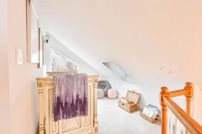 a room with a staircase with a wooden cabinet at Beautiful Mount Pocono Chalet with Hot Tub!! in Tobyhanna