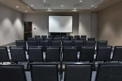 a conference room with chairs and a projection screen at Courtyard by Marriott Philadelphia South at The Navy Yard in Philadelphia