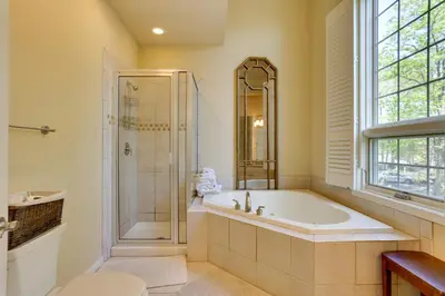 a bathroom with a tub and a glass shower at Half-Mi to Big Boulder Lake Townhome with Deck! in Lake Harmony