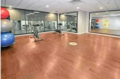 an empty gym with a wooden floor and a bowling alley at Furnished Quarters at Grove Pointe in Jersey City